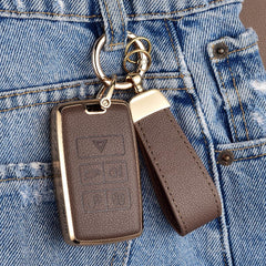 Axtrulix key fob in hand demonstrating compact scale and ergonomic grip