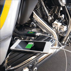 Battery Tender adapter connected to a motorcycle battery, provides on-the-go device charging