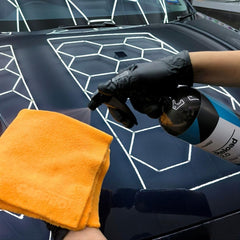 CARPRO Reload 2.0 being wiped on a panel showing easy spray-on wipe-off application benefit