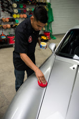 Chemical Guys being applied to a car panel delivering even coverage and easy layering