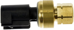 Dorman sensor next to ruler for scale demonstrating compact size and easy installation