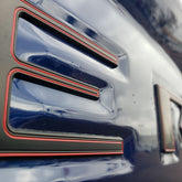 EyeCatcher front view tailgate letters showing bold satin black and red contrast
