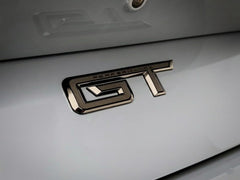 Generic GT emblem close-up showing gloss black ABS texture and durability