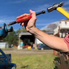 Grease Buster next to a ruler by LockNLube showing compact size and portability