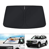 KUST front view showing custom-fit shade protecting windshield for cooler cabin