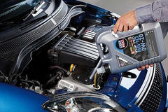 Liqui Moly bottle being poured into engine, demonstrating clean transfer and accurate quantity