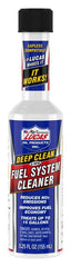 Lucas Oil renewal kit staged in a garage by a vehicle to show easy at-home performance maintenance