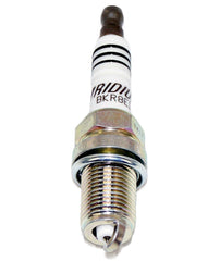NGK spark plug in hand showing scale and compact design for easy installation