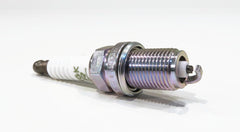 NGK four plugs arranged to show scale for multi-cylinder replacement convenience