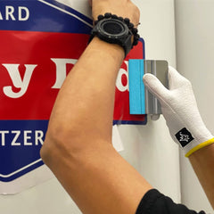Off-Wrap squeegee smoothing vinyl on curved panel for bubble-free adhesion