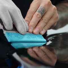 Off-Wrap squeegee next to hand to show size and ergonomic grip benefit