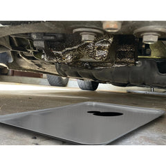 Performance Tool W4048 placed under car catching drips during maintenance