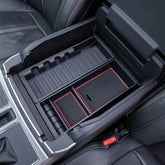 PIMCAR front view of red-trim console tray showing neat storage and accessibility