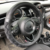 PINCTROT front view of all-black steering wheel cover showing grip benefits