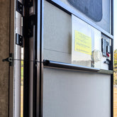 Safoner front view closer installed on RV screen door showing neat fit and protection