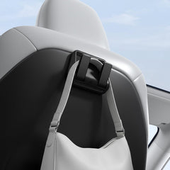 Spigen seat hook front view showing sleek metal design and protective pad for safe seat contact