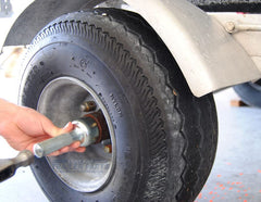 Sturdy Built tool in use on trailer hub speeding installation and preventing damage