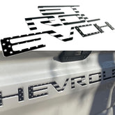 Texflic front view on Silverado tailgate showing clean black emblem and rugged styling benefit