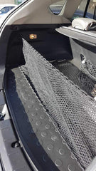 TN TrunkNets securing grocery bags in trunk, protecting contents from rolling