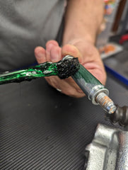 Versachem grease applied to caliper slide demonstrating reduced squeal benefit
