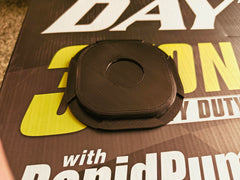 Viper Outlaw pad beside a coin for scale showing size and durable thickness
