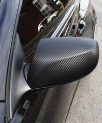 VViViD vinyl being applied to mirror cap illustrating easy air-release installation benefit