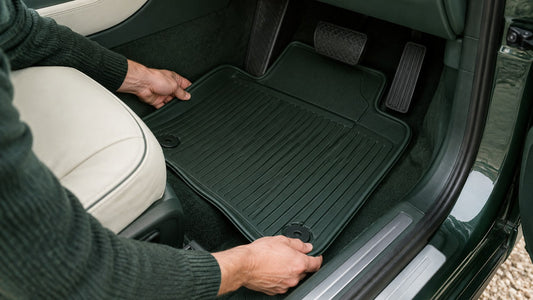 Tailored rubber car mats being fitted into a clean footwell