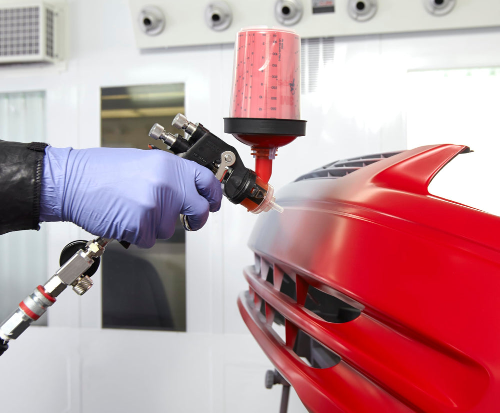 3M Accuspray heads on a workbench in a body shop illustrating fast-change productivity