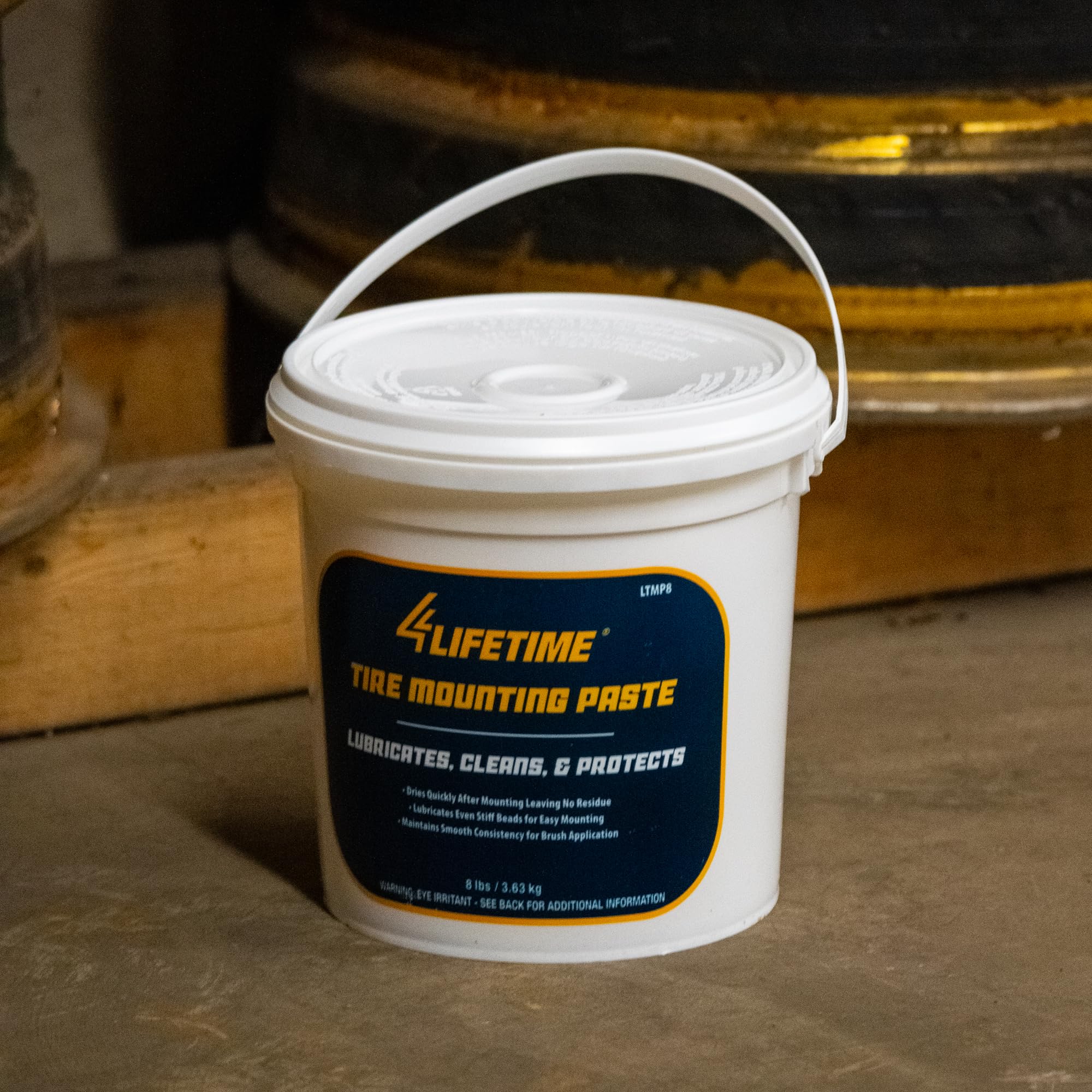 4LIFETIMELINES bucket beside a tire for size and weight reference