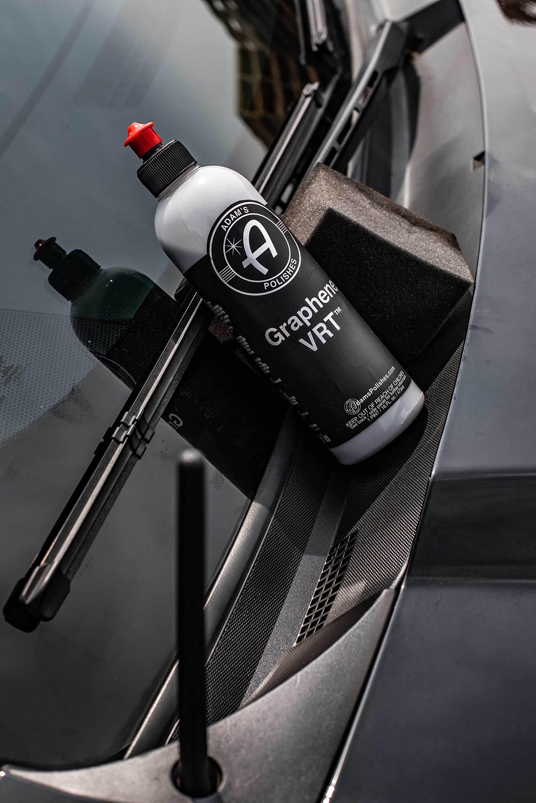 Adam's Polishes used on exterior door trim demonstrating restored dark finish benefit