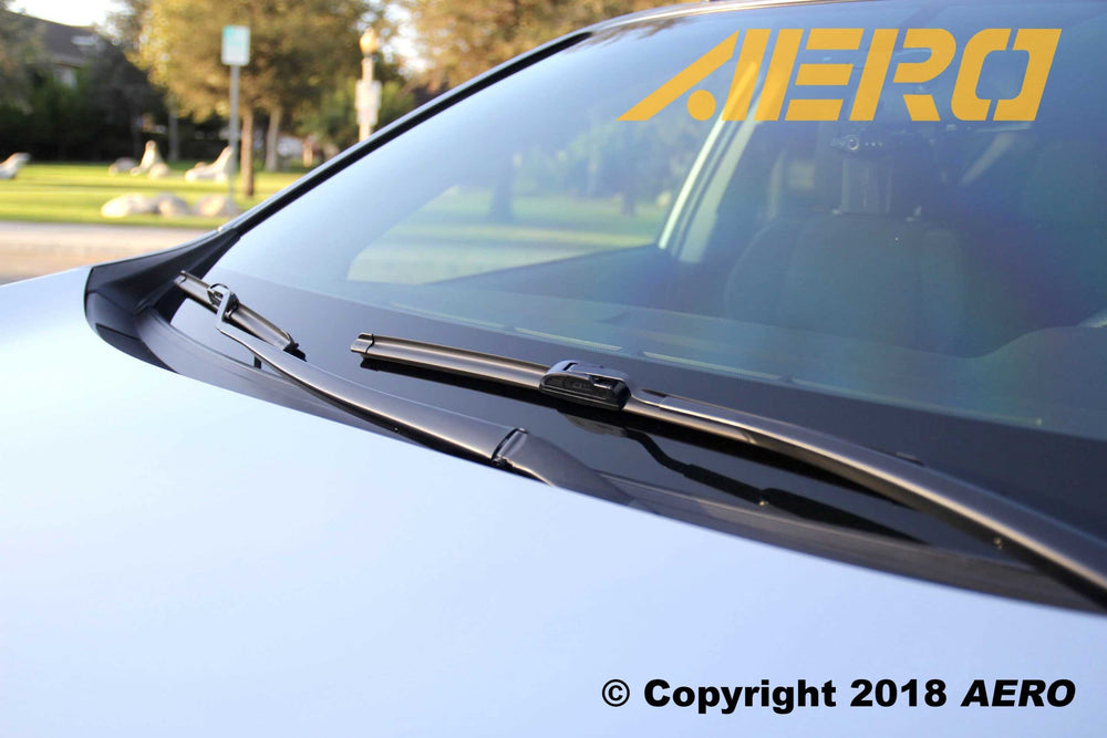 AERO blades clearing rain on windshield enhancing driving visibility in wet weather