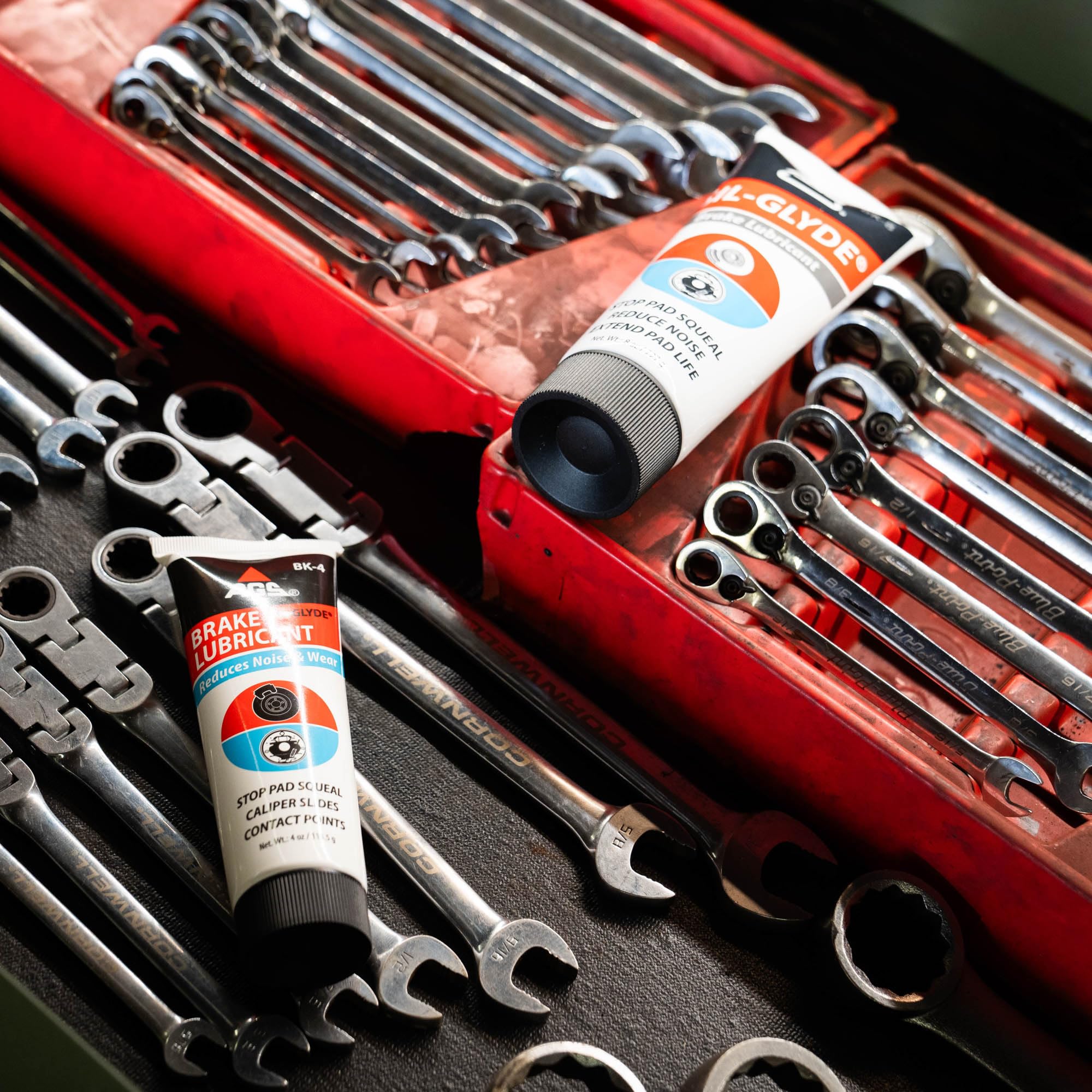 AGS SIL-Glyde in garage setting showing mechanic using product for maintenance
