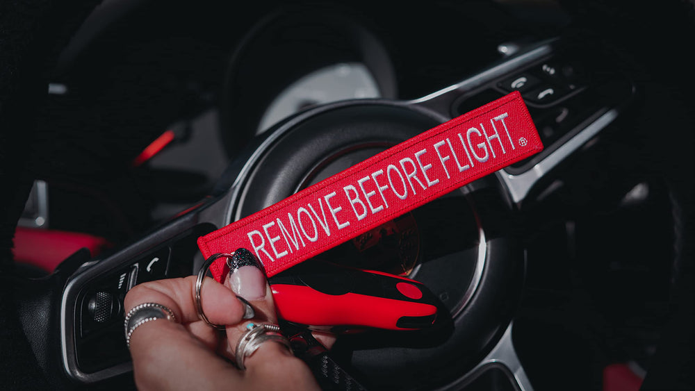 AIXEPA key chain attached to flight bag showing easy identification