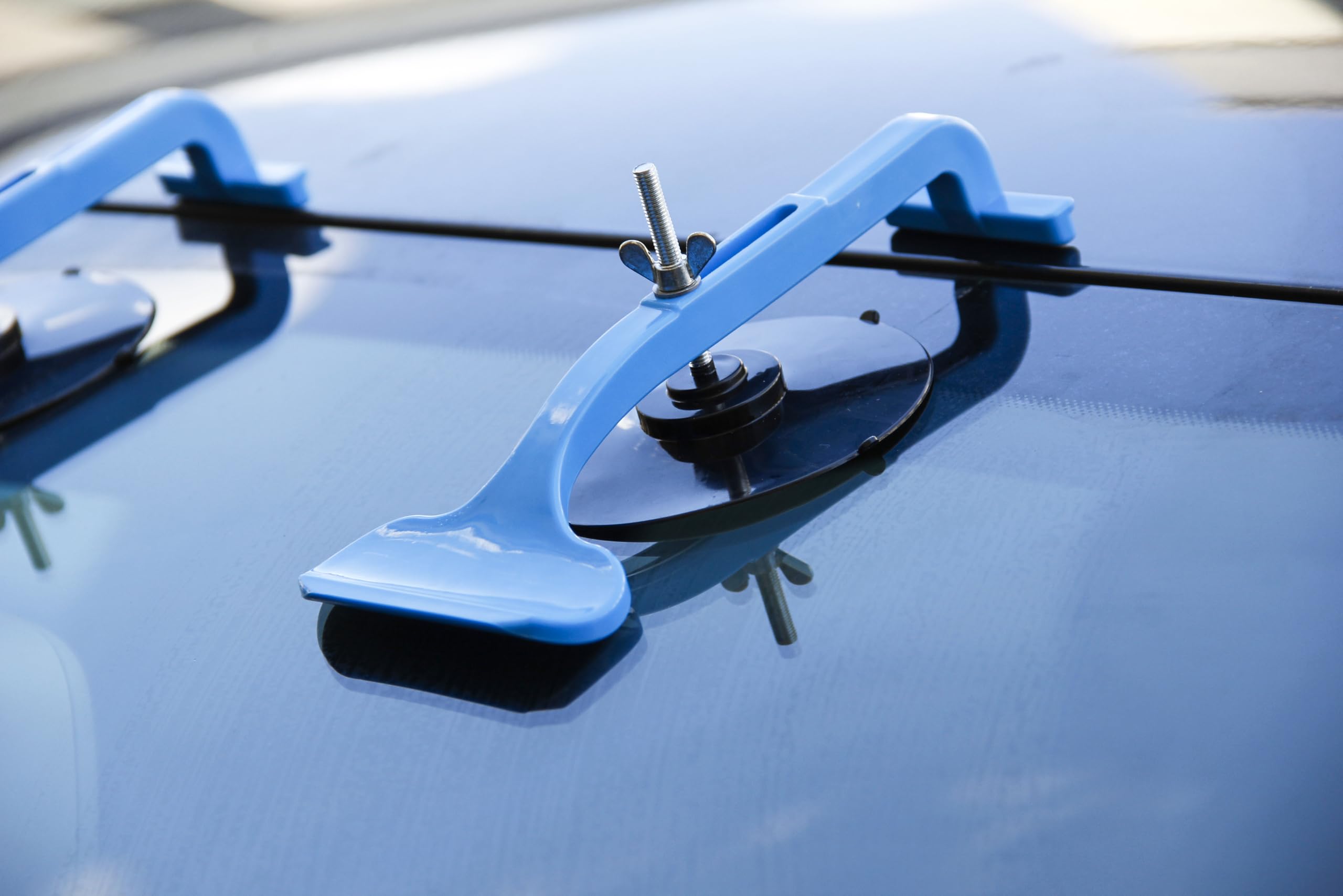 Akuttool clamp securing convertible top edge showing gentle protection and hold