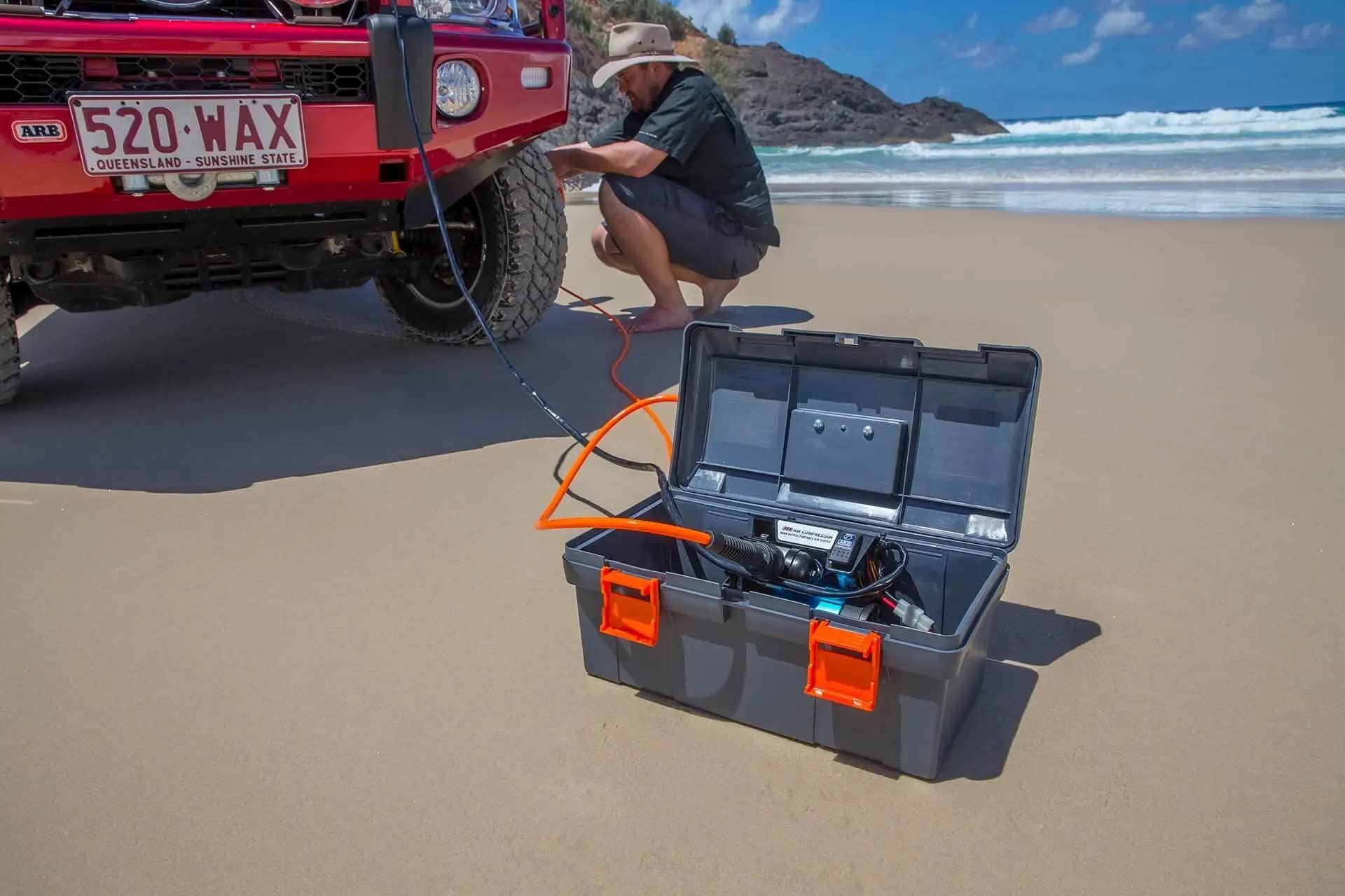 ARB kit in a driveway inflating a tyre for faster roadside repairs