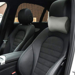 Aukee installed on driver seat headrest showing improved comfort benefit