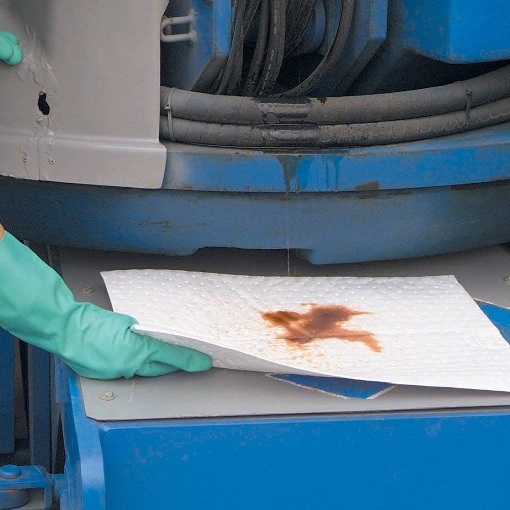 Auto Care pad repelling water droplets, demonstrating oil-only hydrophobic benefit