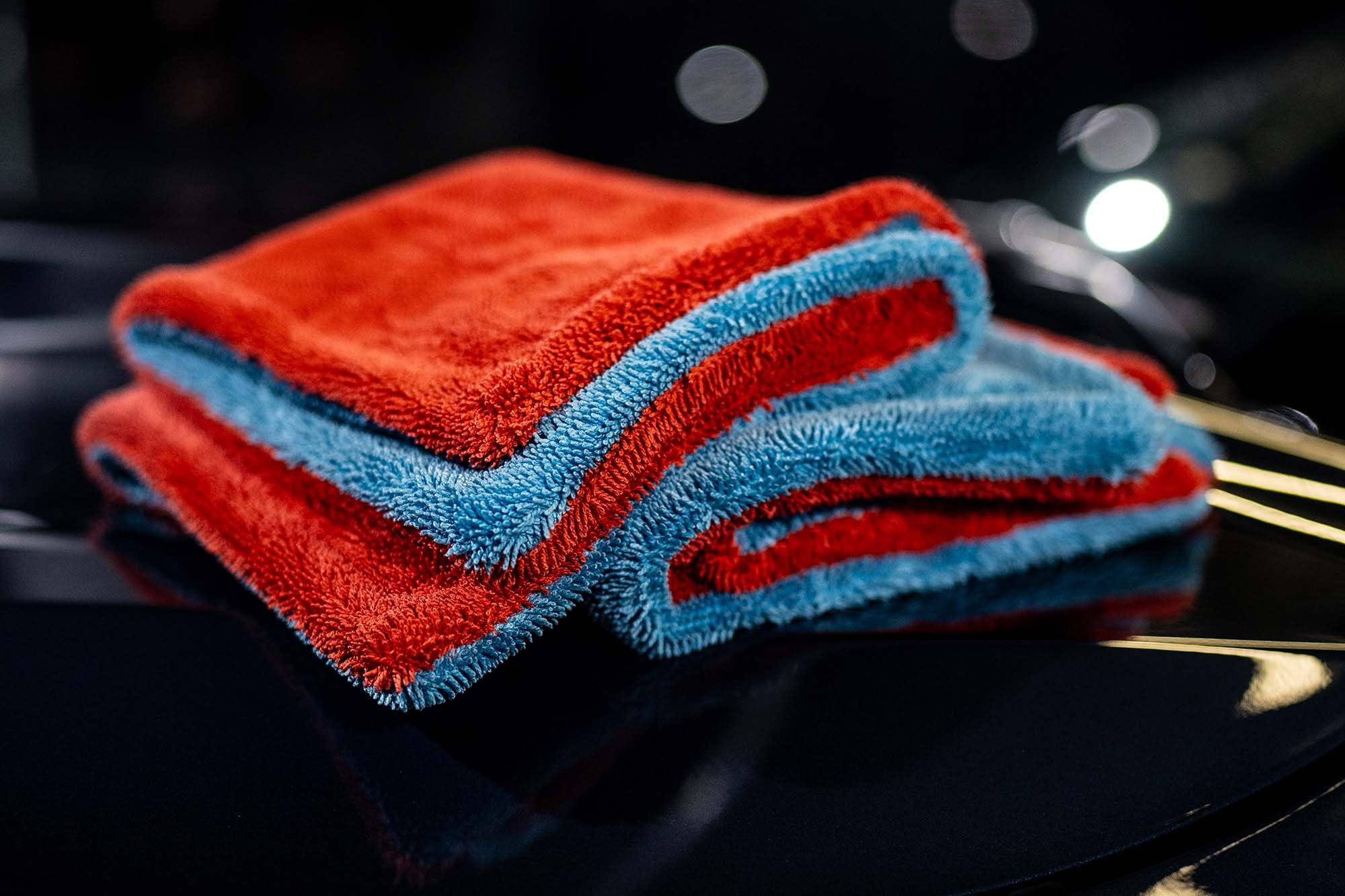 Autofiber towel drying a car door for streak-free finish and faster water removal