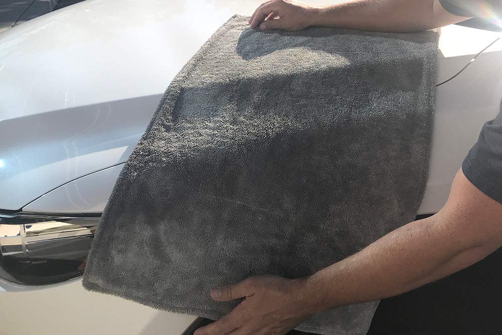 Autofiber Dreadnought size shown in hand to demonstrate 20x30 inch usability