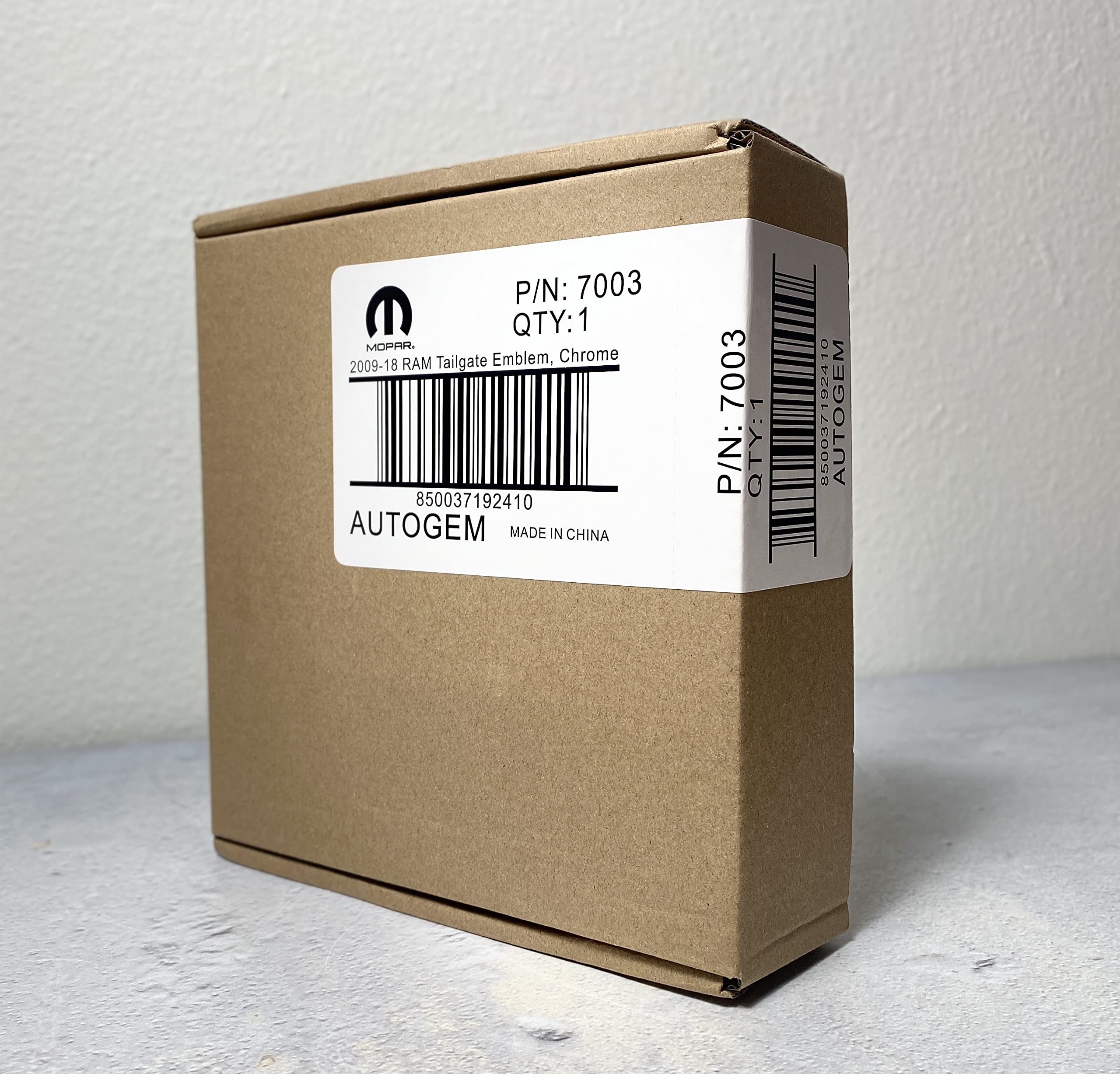 Autogem emblem adhesive backing shown for easy peel-and-stick installation benefit