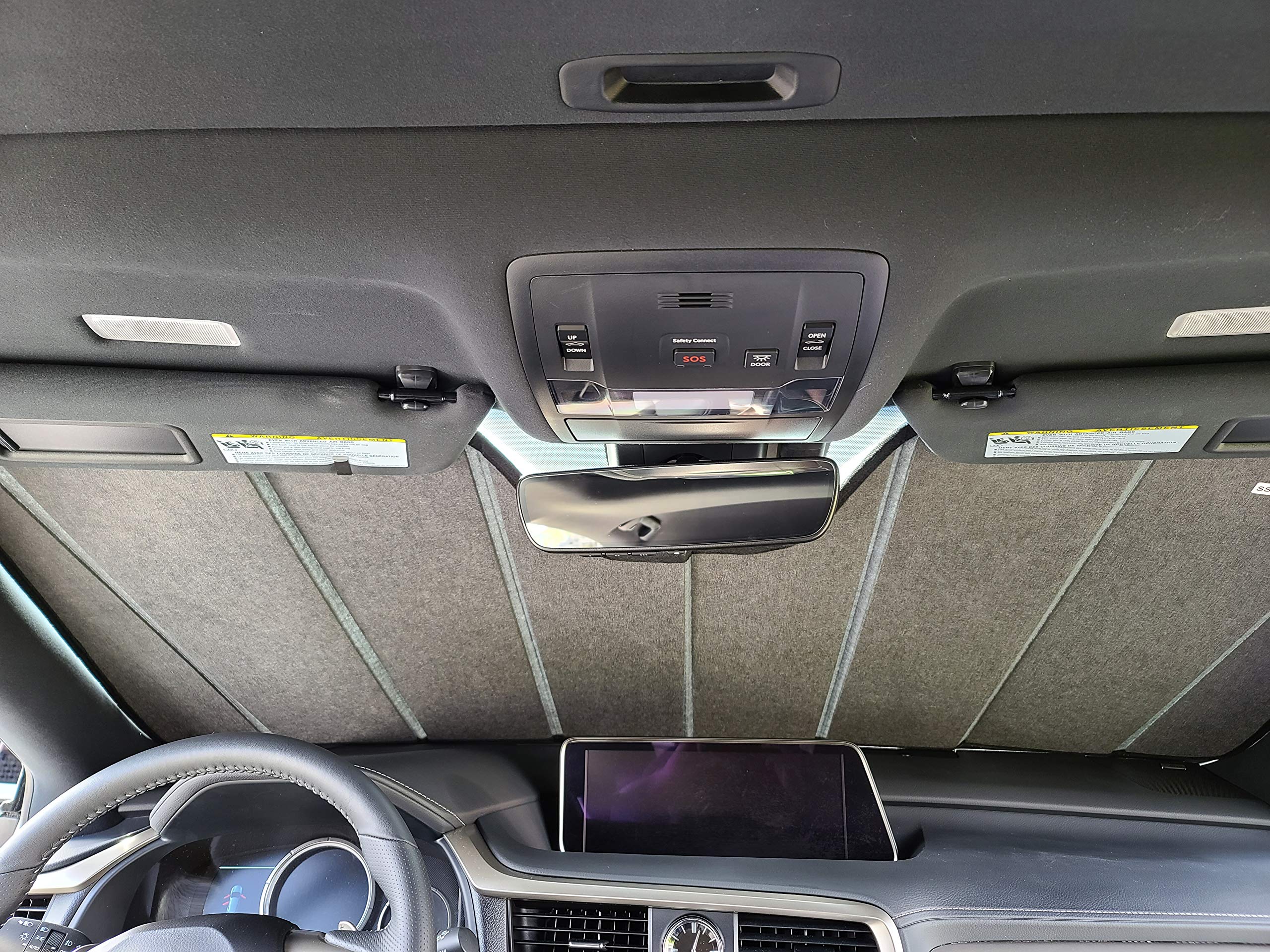 Autotech Park sunshade next to steering wheel for scale showing exact fit and convenience
