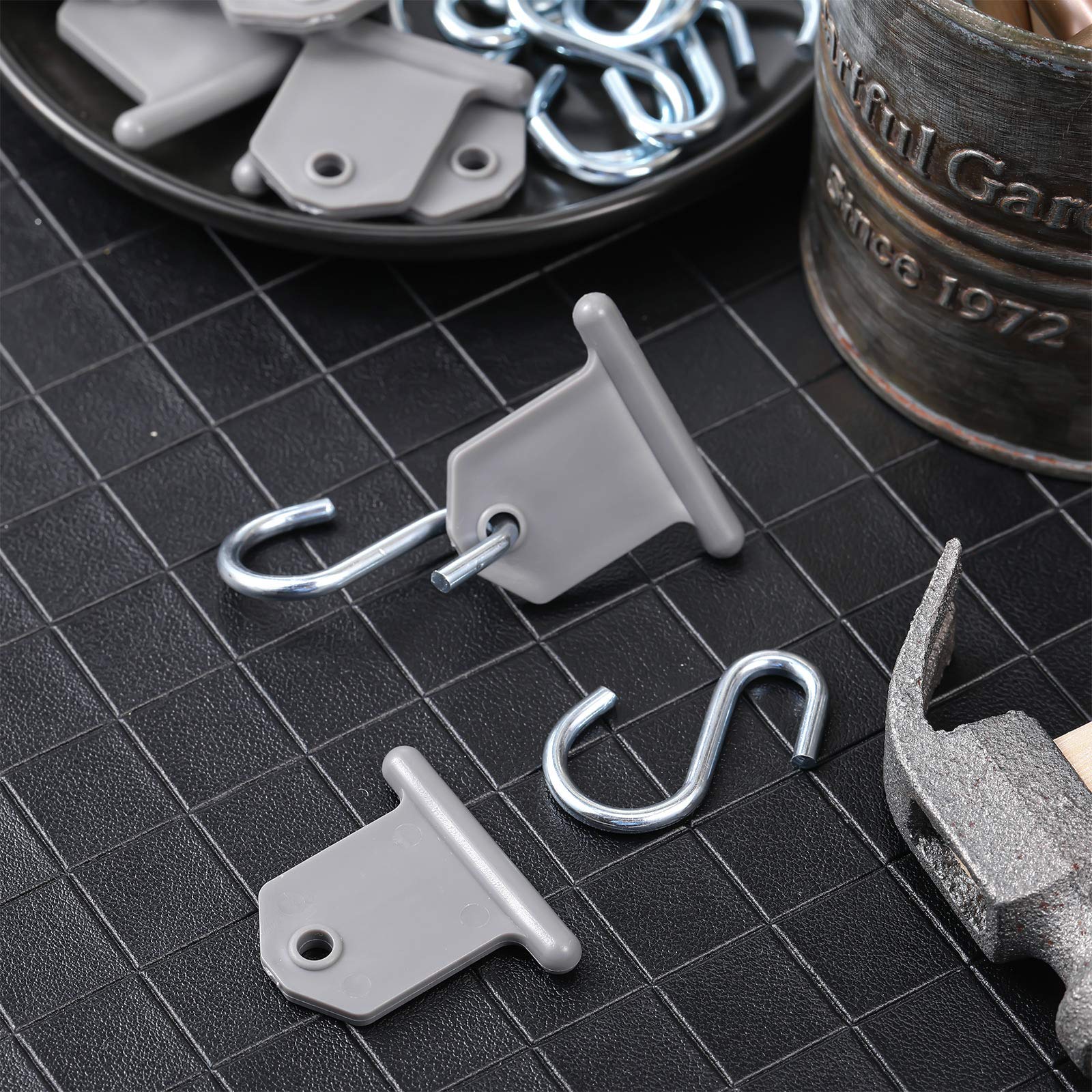 BBTO hook beside a hand for scale illustrating compact travel size