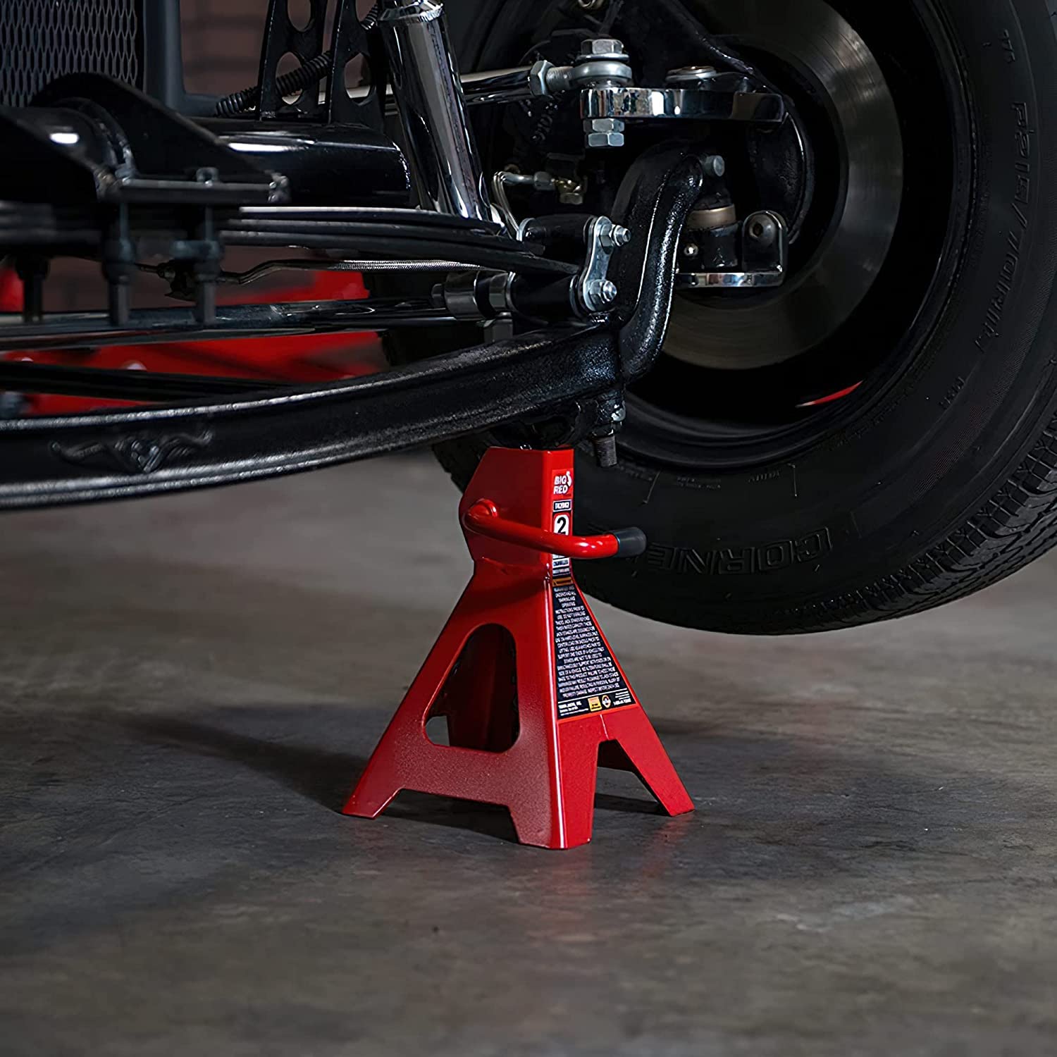 BIG RED stands supporting a car in garage for practical workshop use