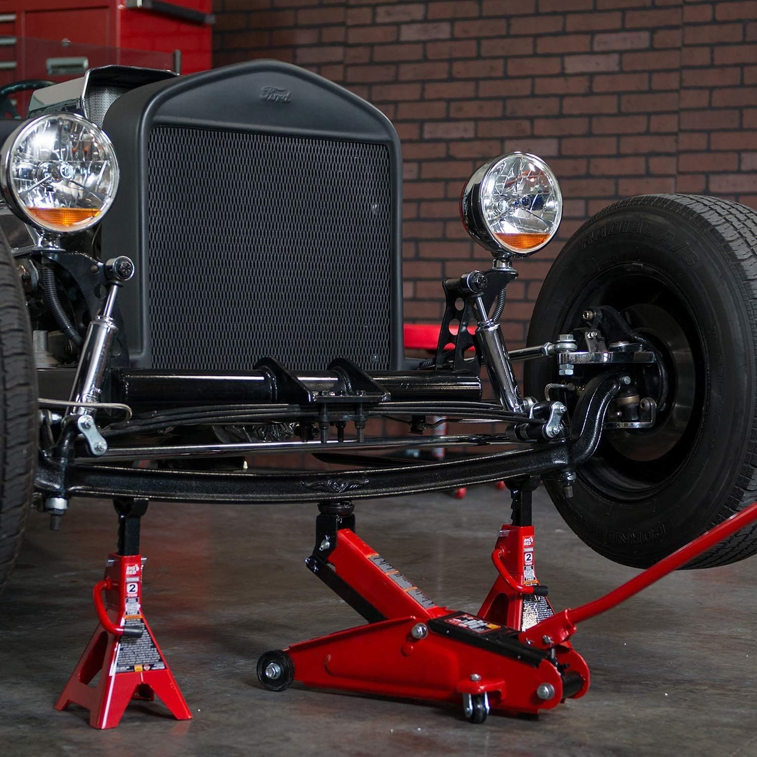 BIG RED in-use lifting a car to illustrate safe support with included jack stands
