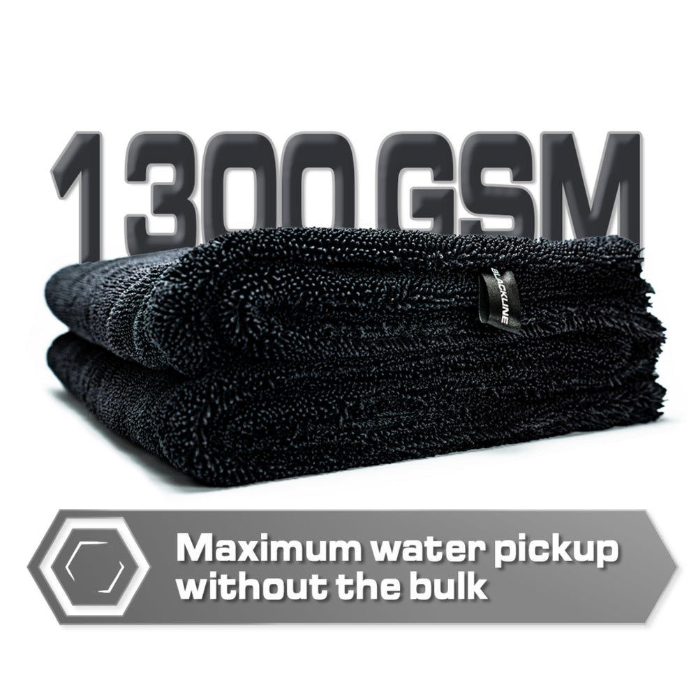 Blackline neatly folded towel with label, indicating easy storage and durability