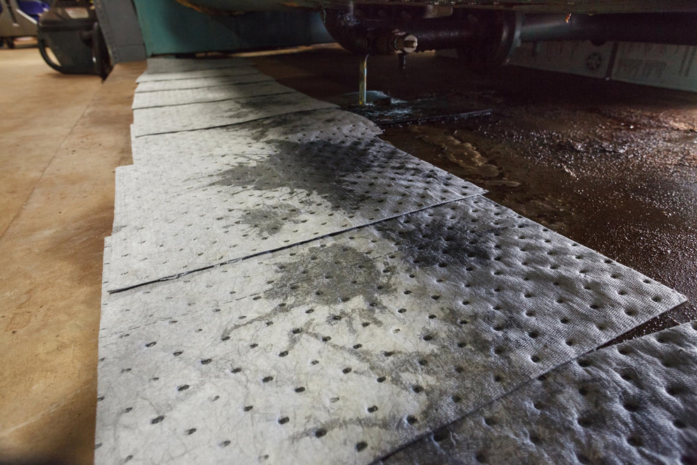 Brady pad placed beside a drum to capture outfall and protect flooring