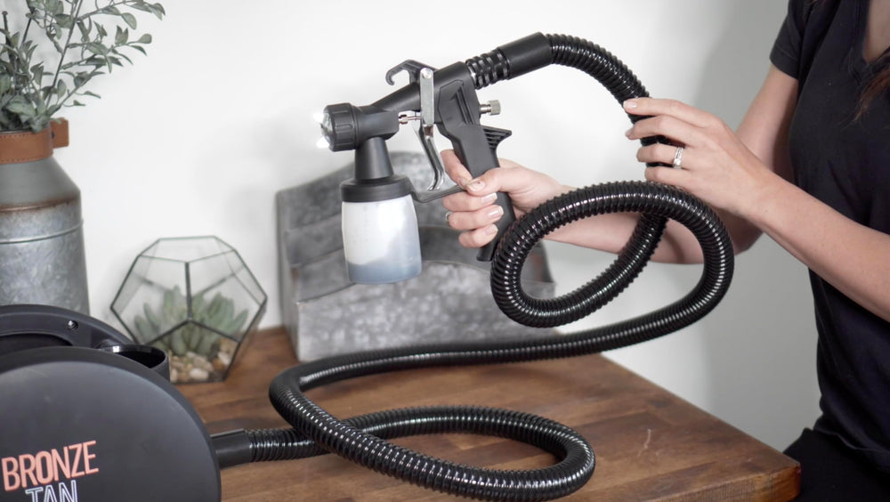 Bronze Tan replacement gun in use in a salon delivering controlled sunless coverage