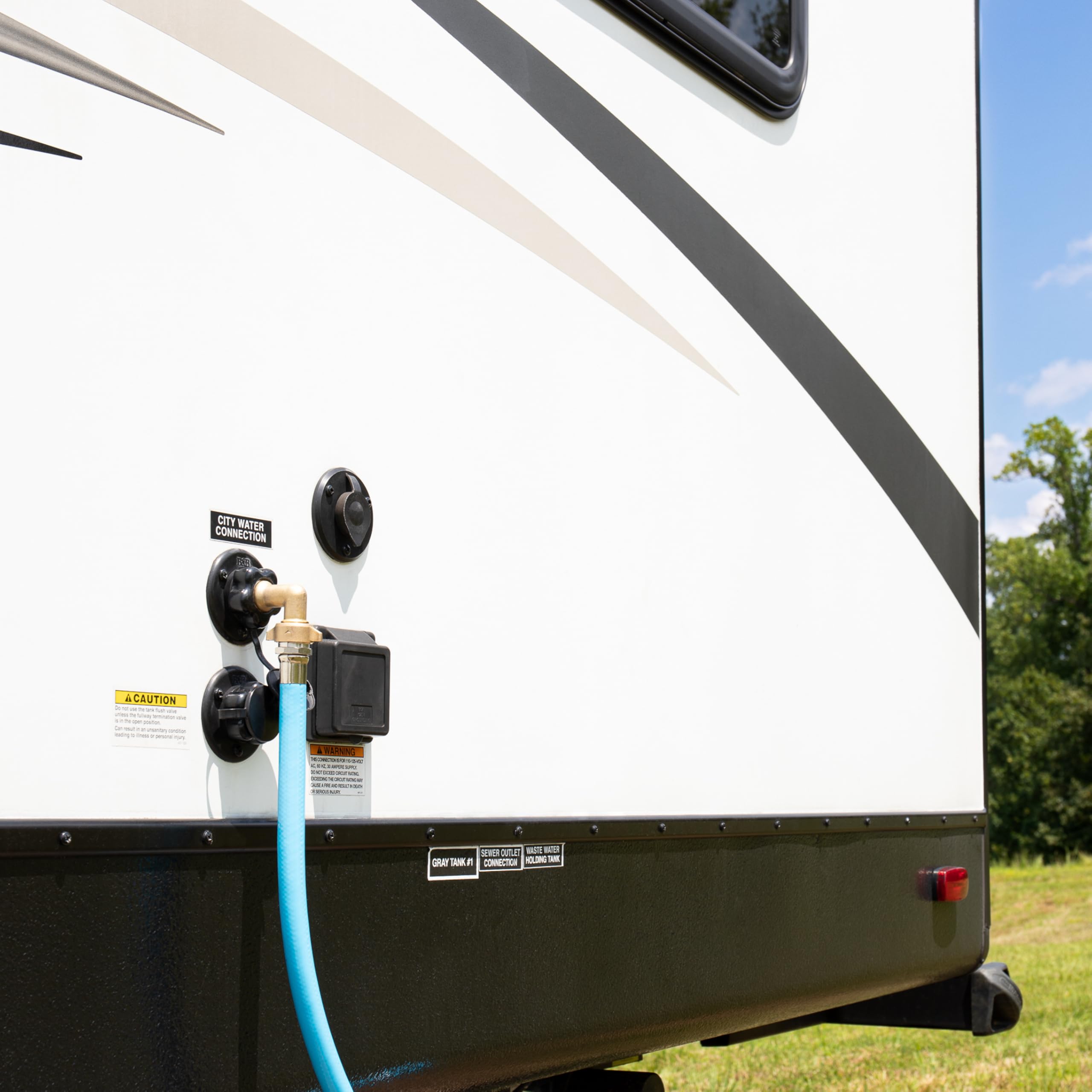 Camco elbow in campsite hookup illustrating tidy, kink-free hose layout