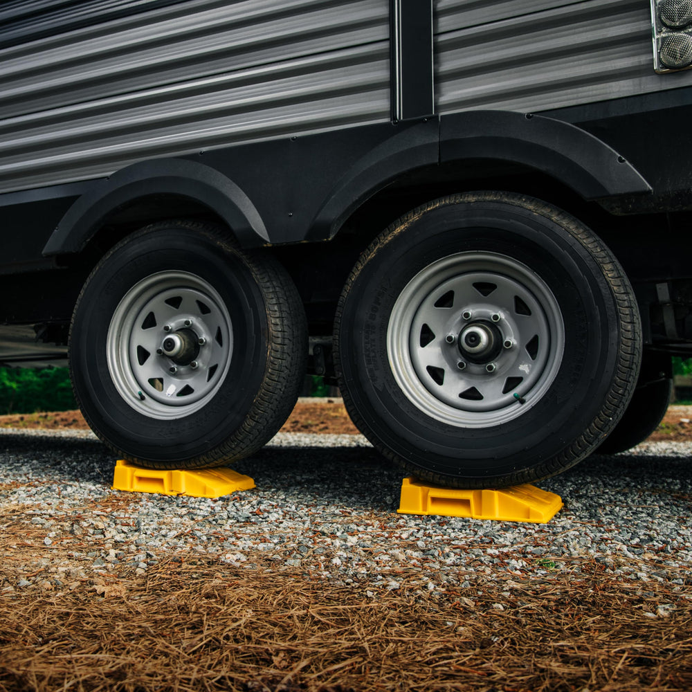 Camco ramp next to hand showing size and portable benefit