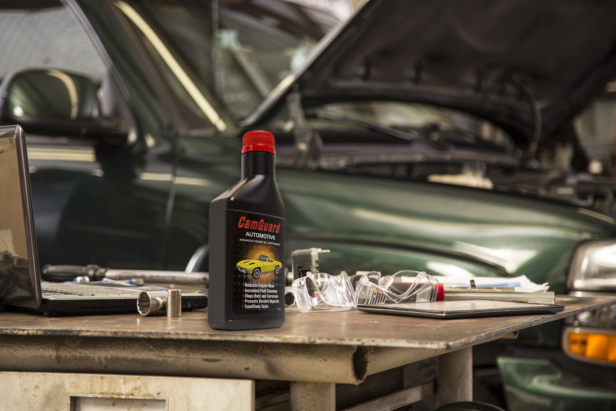 Mechanic in a garage using CamGuard during vehicle maintenance for protection